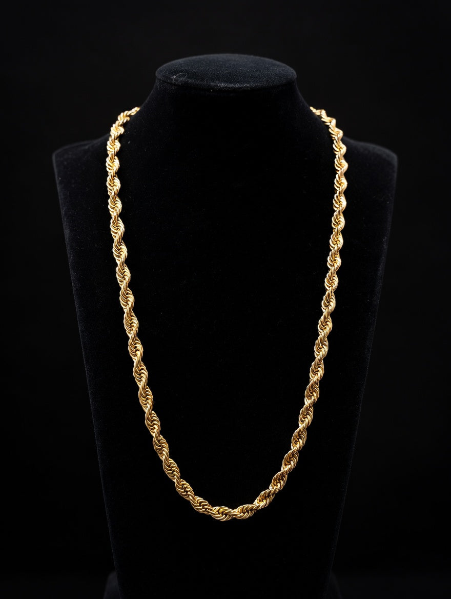 14k yellow-gold rope chain over a black mannequin in front of a black background