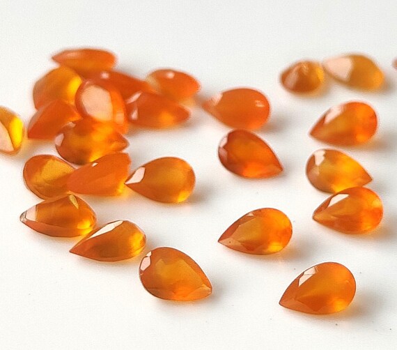group of loose carnelian gems on white background