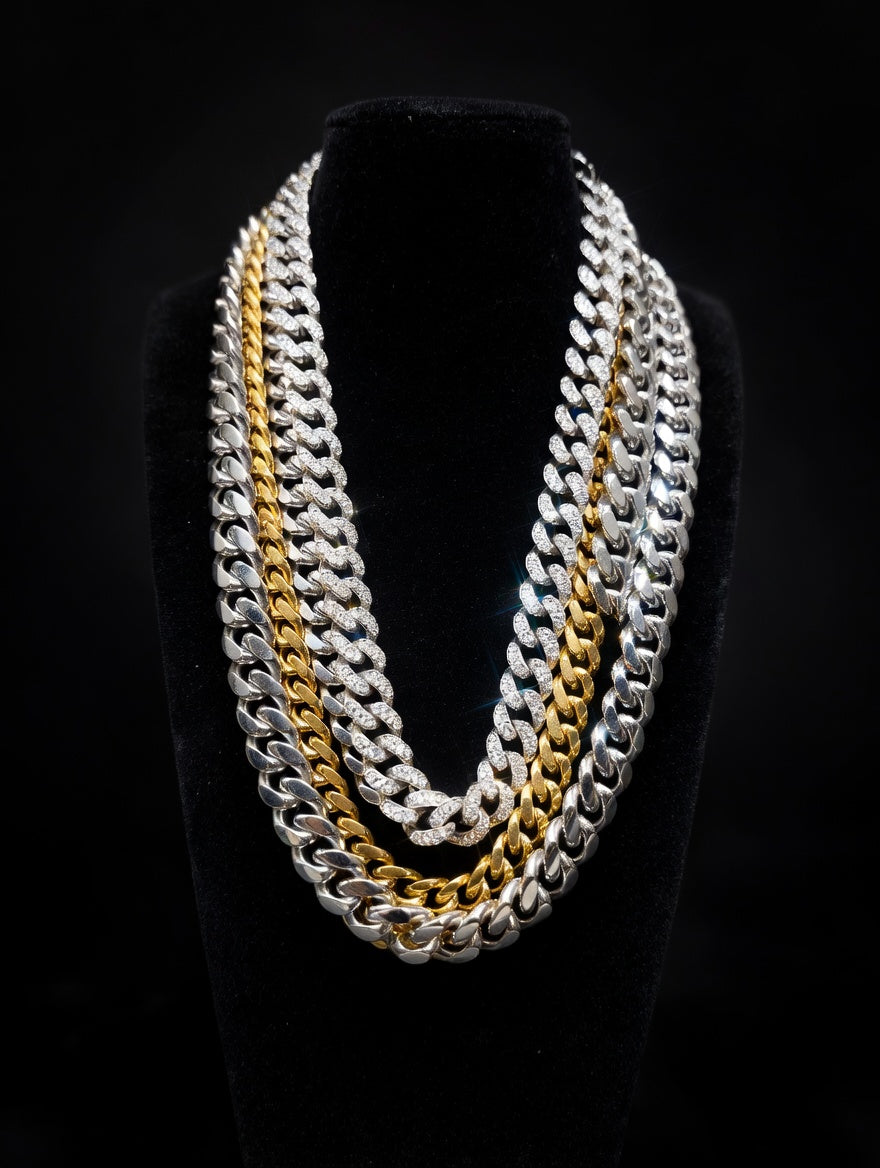 cuban chains of colors silver and gold arranged on a black velvet bust in front of a black background