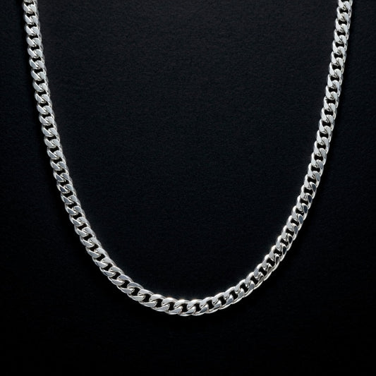 Silver chain necklace on a black background