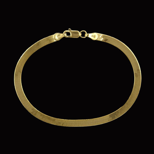 Gold plated over brass, herringbone bracelet on a white background