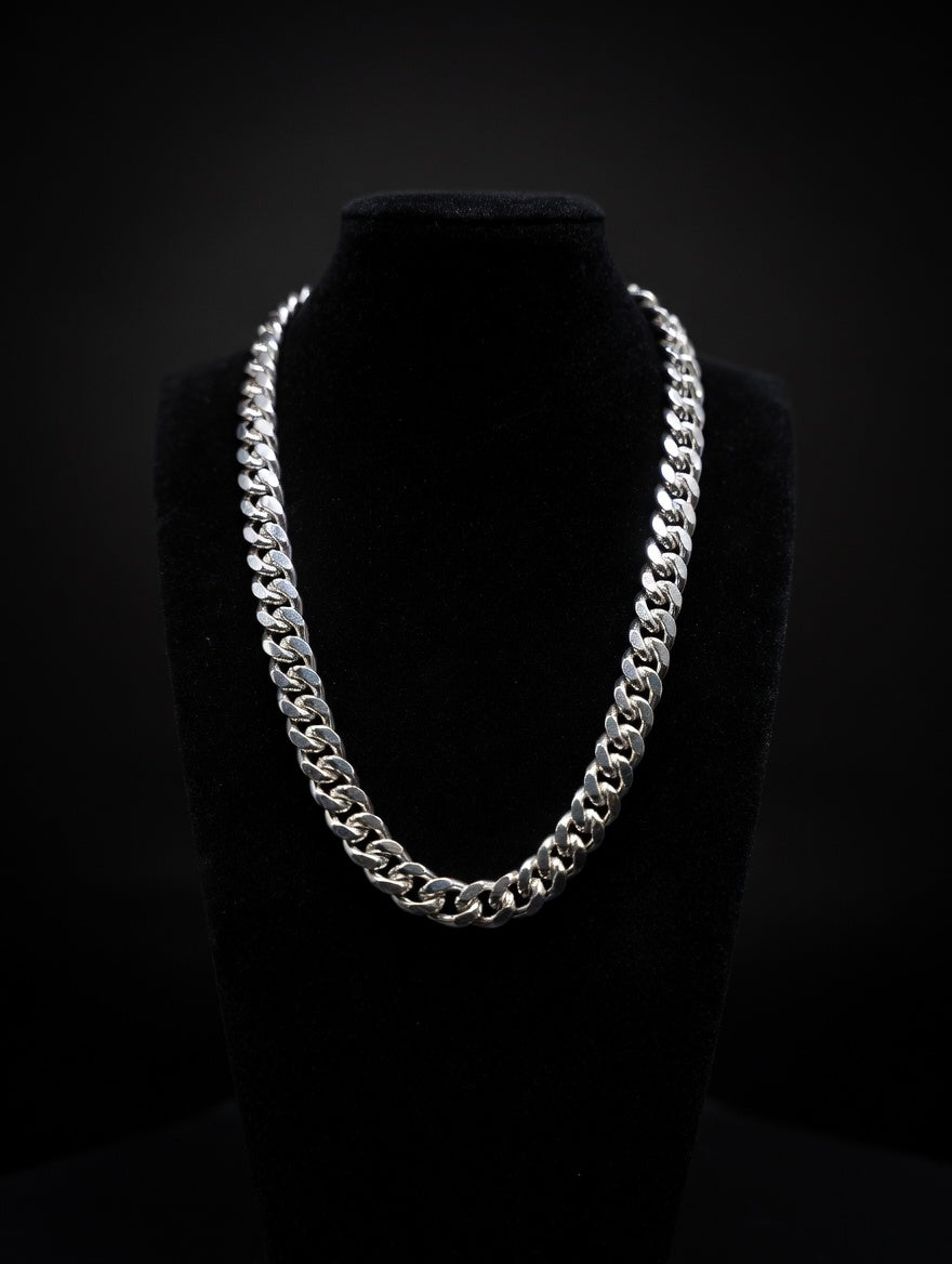 Silver Miami cuban chain necklace on a black mannequin against a black background
