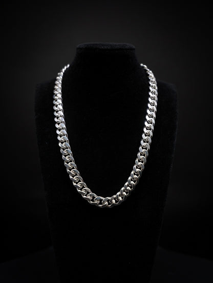 Silver Miami cuban chain necklace on a black mannequin against a black background