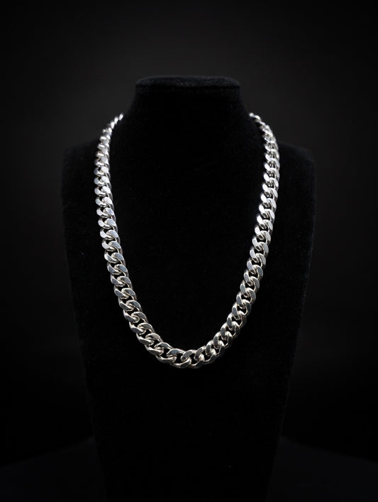 Silver Miami cuban chain necklace on a black mannequin against a black background