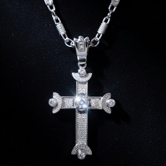 Silver cross pendant necklace on a black background