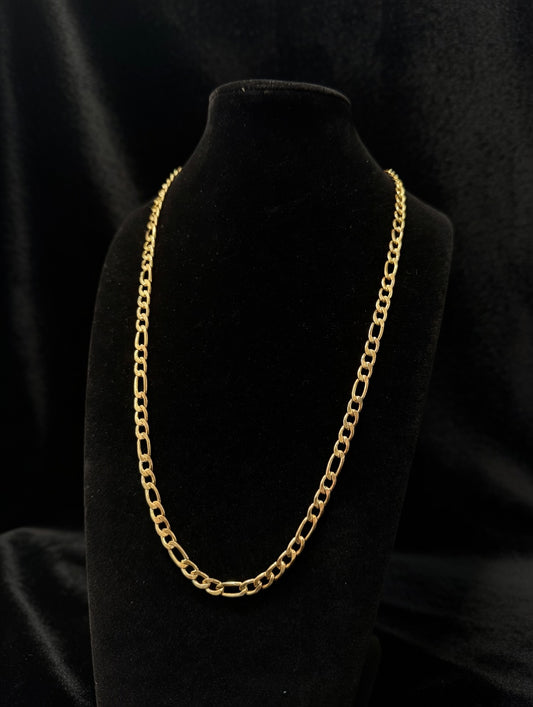 Gold figaro chain necklace on a black mannequin bust against a black background